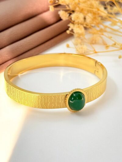 Eye twist green gold plated bangle