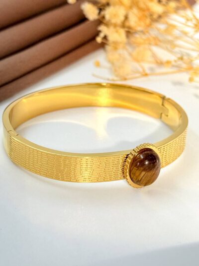 Eye twist brown gold plated bangle