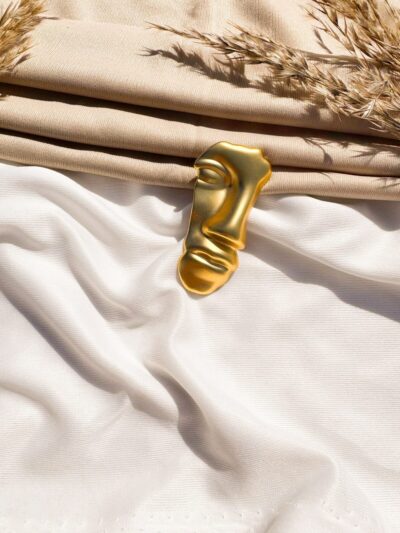 Golden face Brooch